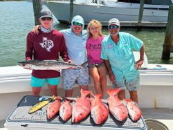 Fishing charter catch display showing king mackerel, red snapper, and mahi mahi from Port O'Connor TX