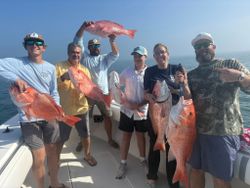 Successful red snapper fishing trip displaying multiple caught fish on boat deck in Port O'Connor TX