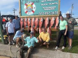 Successful red snapper fishing trip in Port O'Connor TX with nine large red snapper displayed on wooden rack