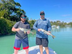 Two anglers with fishing rods in Fort Myers