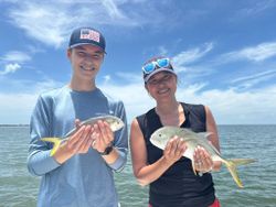 Two anglers hold their catch of two fish in Florida.