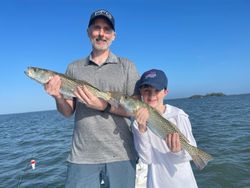Two anglers fishing in Florida with two fish