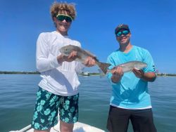 Two redfish in a sunny Florida fishing adventure
