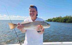 Angler holding freshly caught redfish on fishing charter in Fort Myers FL