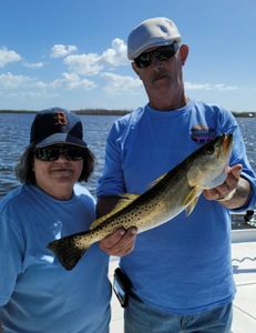 A person fishing for a spotted weakfish in Fort Myers