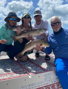 Anglers catch two big redfish during a holiday fishing trip