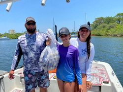 Three people enjoying a holiday fishing trip