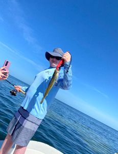 A person fishing during a holiday getaway
