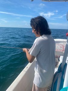 Person enjoying a holiday fishing trip