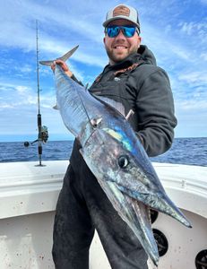 A person fishing at Barnegat Light, with a 27-inch catch.