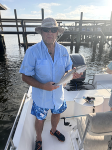 A feisty redfish caught on a sunny day with a side of rain!