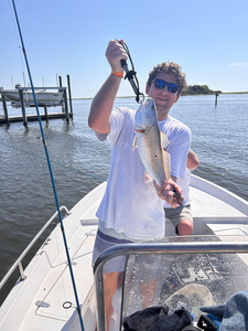 Reeling in a redfish while deep sea trolling off Wilmington's coast!