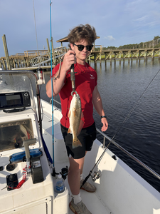 A massive redfish reeled in under partly cloudy skies with late afternoon rain showers.