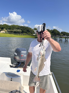 Reeling in the redfish with light tackle in cloudy Wilmington waters!