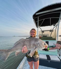 A lone angler fishing for a black drum in TX.