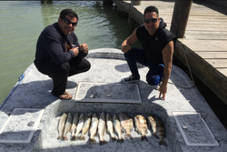 Two anglers fishing in Texas with one small fish