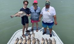 Two black drum fish caught by three people in Port Isabel