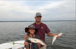 2 fishing rods with a catch of 2 fish on the beach in FL