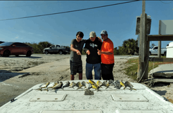 Three people fishing on the coast of FL