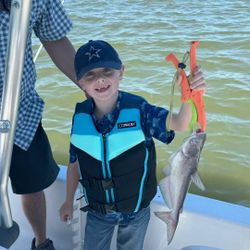 Angler holding a blue catfish in Cedar Shores
