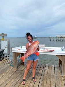 A person fishing in Gulf Shores