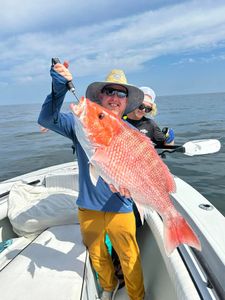 Two people enjoying a fishing trip in the beautiful Gulf Shores location