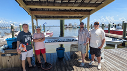 Reeling in the big catch at Fort Morgan Marina on a partly cloudy day!