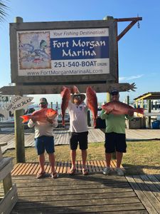 Three people fishing on the waters of Gulf Shores