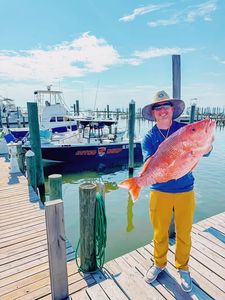 Large red snapper displayed at marina dock in Gulf Shores AL after successful fishing trip