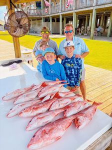 Red snapper fishing catch displayed on cleaning table at Gulf Shores AL marina