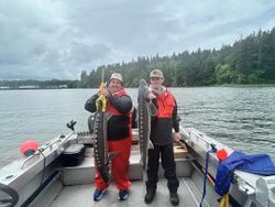 Two white sturgeon, each measuring 41 inches, being fished in Astoria