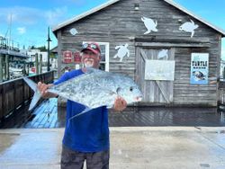 Triumphant angler with large African Pompano fish caught in FL