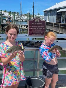 Two anglers reeling in a big catch in Key West