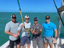 A group of 4 people fishing in Key West