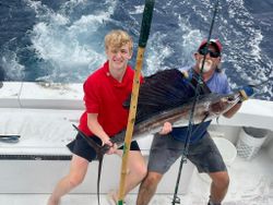 A fisherman holding a huge Atlantic Sailfish in FL