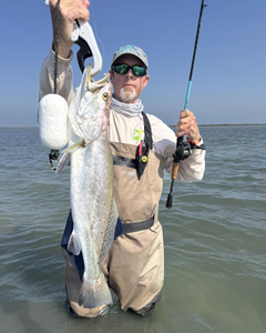 Two anglers holding a freshly caught fish in TX