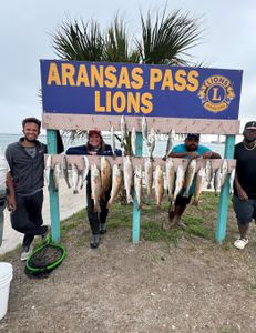 Two fishermen holding their catch in Aransas Pass