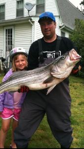 An angler with a large 23-inch fish caught in Bourne