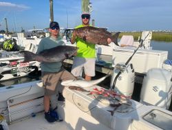 Two people fishing at Murrells Inlet with 3 fish