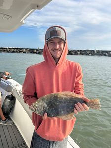 Angler catching a summer flounder in SC