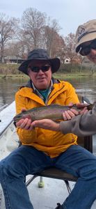 Angler holding rainbow trout in AR
