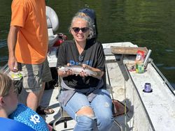 Angler with 12-inch rainbow trout in AR