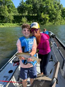 Angler holding a rainbow trout in AR