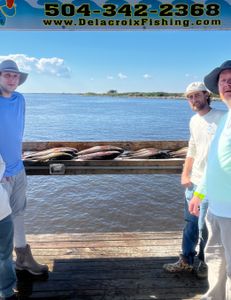 Three people fishing on the coast in LA