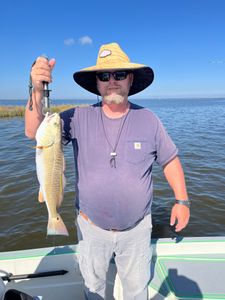 An angler holds a fishing rod in St Bernard