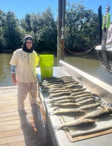 A person fishing for 2 big fish in St Bernard