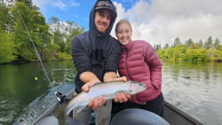 A fisherman catching a large Coho Salmon in Central Point