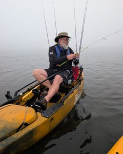 Kayak fishing setup with multiple rods on calm water in Tallahassee FL