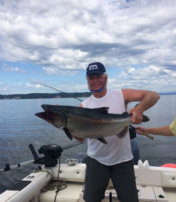 Angler fishing in Zeballos, holding a 23-inch fish