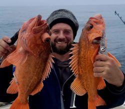 Two people fishing with 2 fish in CA